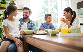 family with young children eating breakfast